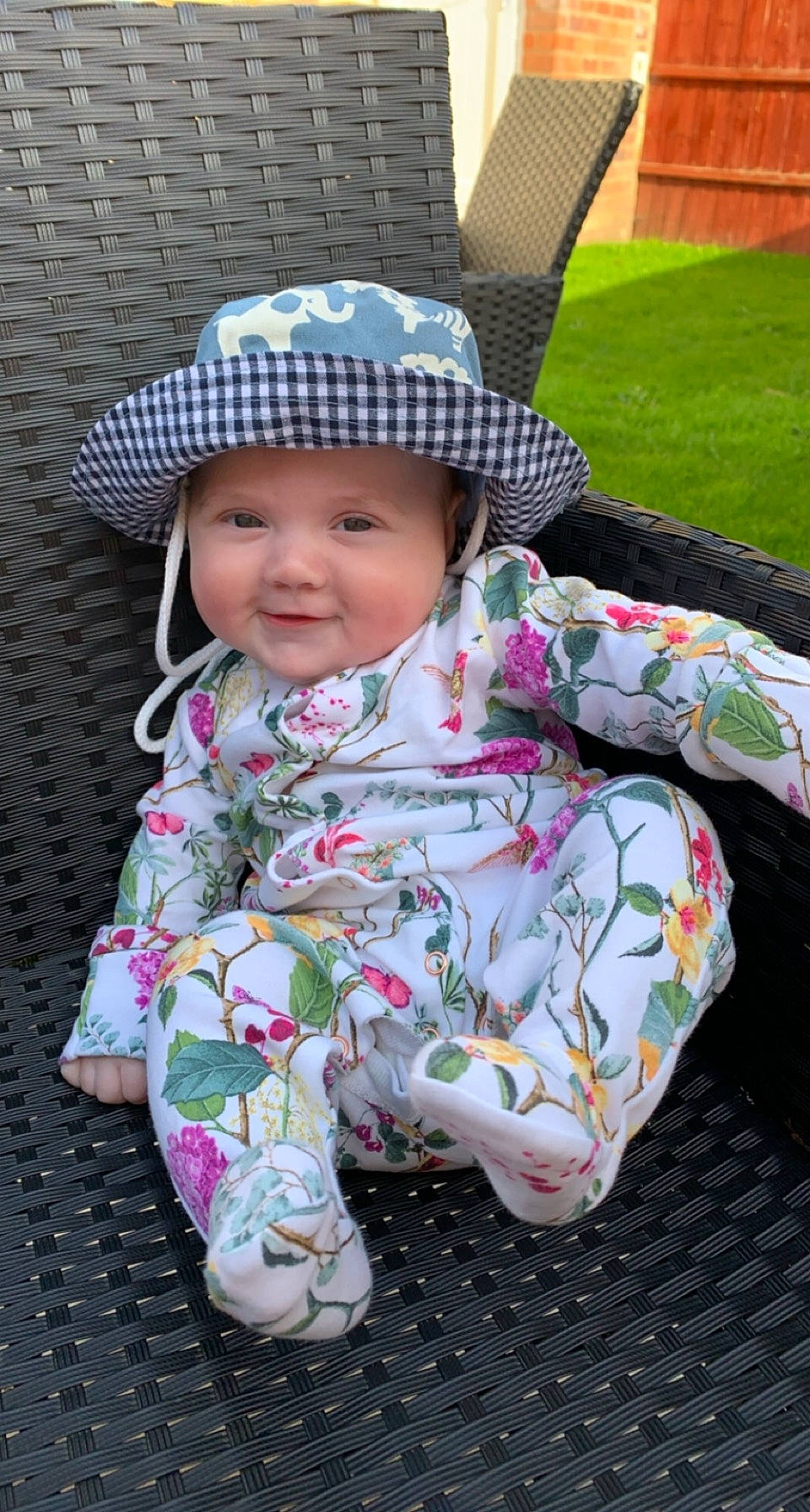 Harriet joined the competition — help win amazing prizes! baby, baby_toddler_clothing, child, face, fun, grass, happy, hat, head, headgear, headwear, mammal, pattern, person, pink, plant, skin, sleeve, smile, sun_hat