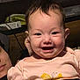 Lila is registered to the contest to win money with this photo: baby, smiling, child, indoor, pink_shirt, butterfly, face, person, couch, furniture, happy, portrait, infant, clothing, human, head, sitting, expression, young_child, casual