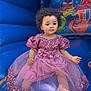 barefoot, blue, bounce_house, child, colorful, curly_hair, cute, event, flower_belt, fun, indoor, inflatable, party, pink_dress, play_area, portrait, sequin, sitting, toddler, young_child