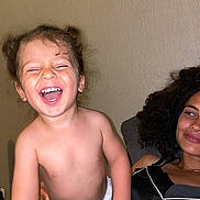 Leyann participe au concours pour gagner de l'argent avec cette photo : toddler, child, laughing, diaper, happy, cute, pigtails, woman, adult, curly_hair, indoor, portrait, skin, smile, joyful, family, people, human, expression, emotion