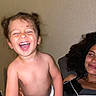 toddler, child, laughing, diaper, happy, cute, pigtails, woman, adult, curly_hair, indoor, portrait, skin, smile, joyful, family, people, human, expression, emotion
