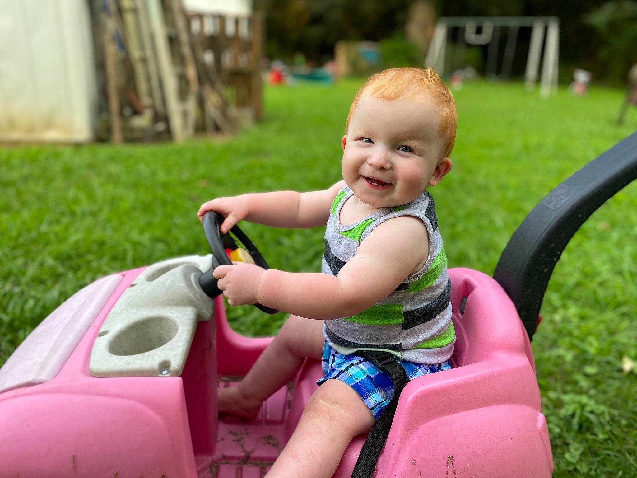 Gavyn joined the competition — help win amazing prizes! baby, baby_toddler_clothing, child, city, fun, grass, happy, joy, lawn, leisure, people_in_nature, person, photograph, pink, recreation, riding_toy, shorts, skin, smile, snapshot