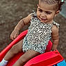 baby, child, curly_hair, cute, face, fun, hair_bows, happy, outdoor, patterned_clothing, person, play, playground, skin, slide, smile, summer, toddler, toy, white_socks
