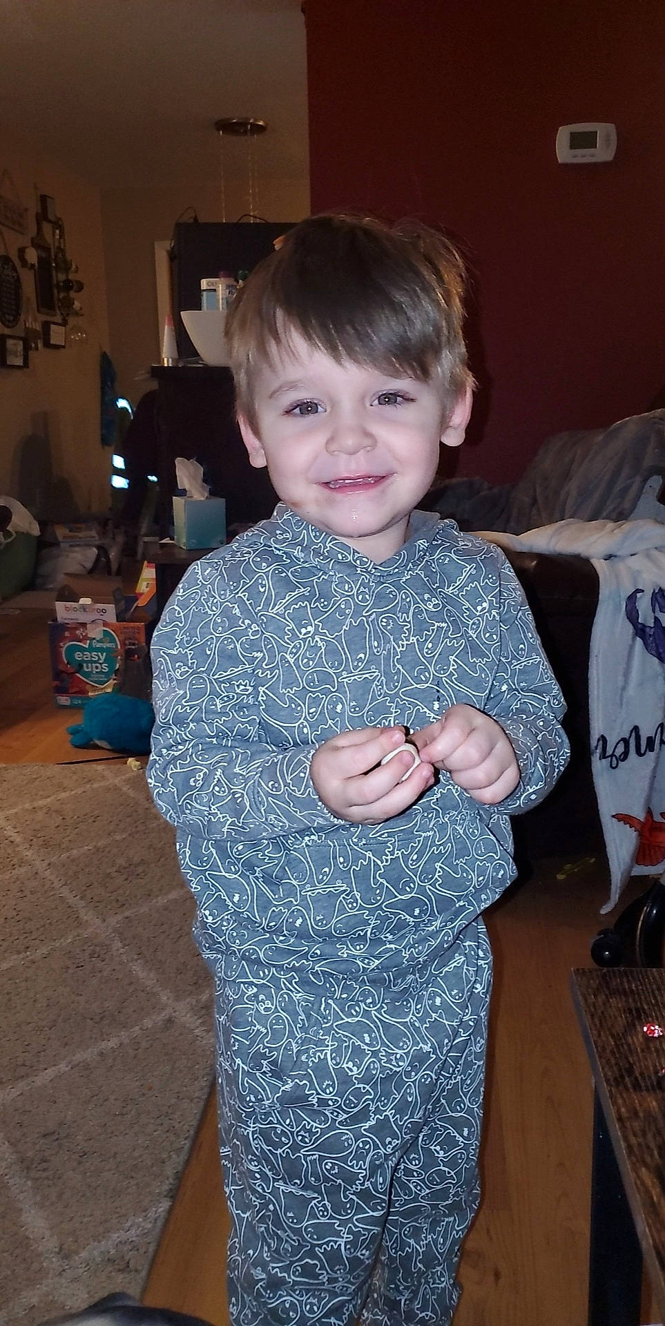 Konner is registered to the contest to win money with this photo: child, couch, electric_blue, event, flooring, fun, gadget, hairstyle, happy, holiday, iris, joy, pattern, person, room, sitting, sleeve, smile, standing, t_shirt