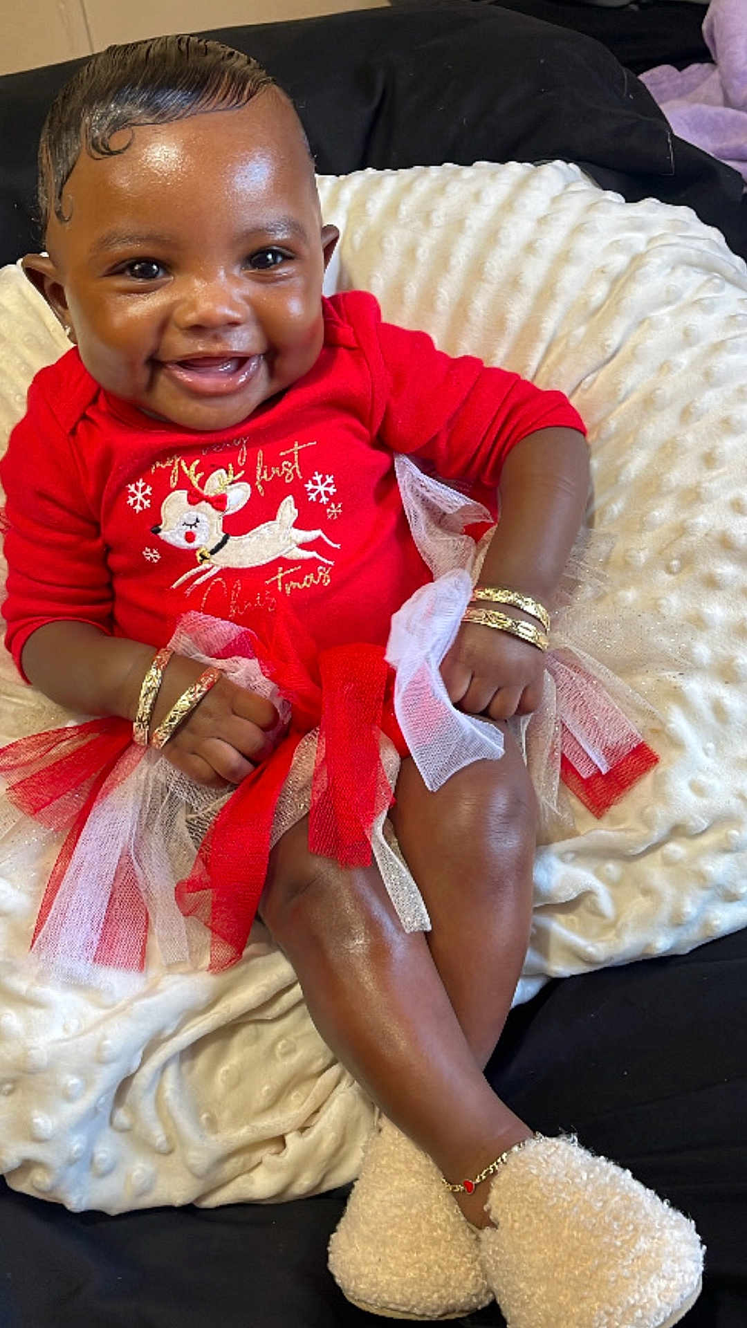 Klahni is registered to the contest to win money with this photo: baby, smiling, red_clothing, reindeer_design, bracelets, white_cushion, soft_texture, tulle_skirt, festive, holiday, happy, sitting, cozy_slippers, anklet, indoors, cute, child, portrait, closeup, joyful