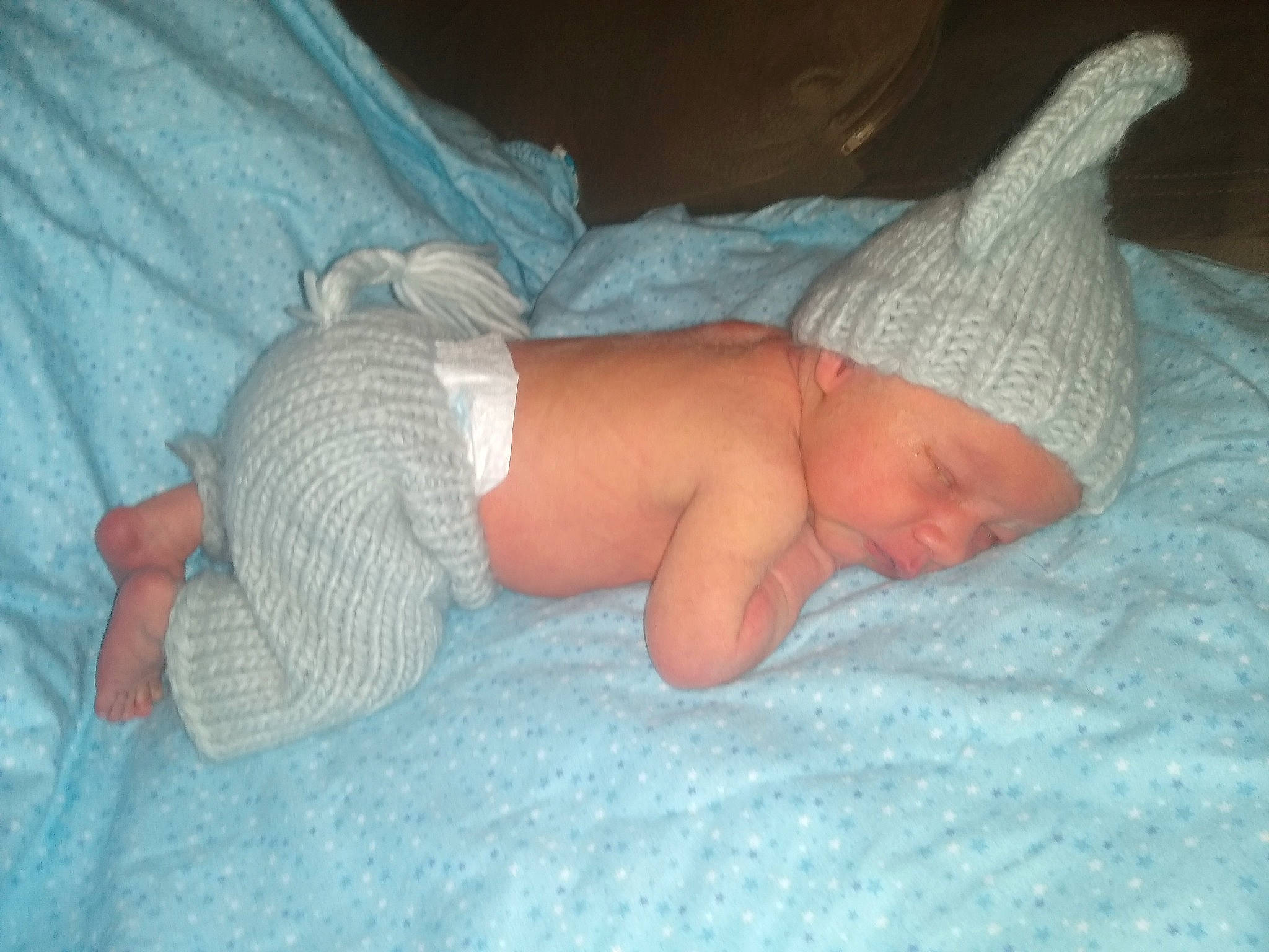 Myles is registered to the contest to win money with this photo: baby, baby_sleeping, baby_toddler_clothing, bedtime, child, comfort, elbow, finger, foot, headwear, human_body, human_leg, lap, linens, mouth, nap, person, skin, sock, textile