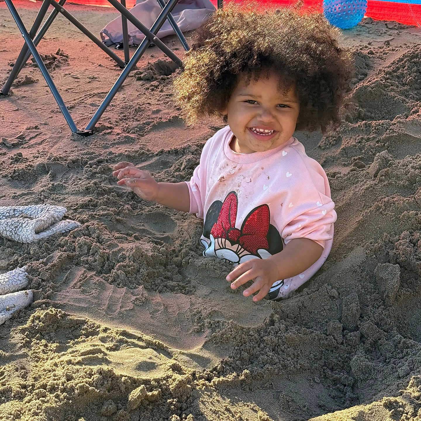 Kylah-Rose joined the competition — help win amazing prizes! ball, beach, chair, child, colorful, curly_hair, fun, happy, minnie_mouse, outdoor, pink_sweater, play, portrait, sand, sand_pile, smiling, sunlight, toddler, towel, windbreak