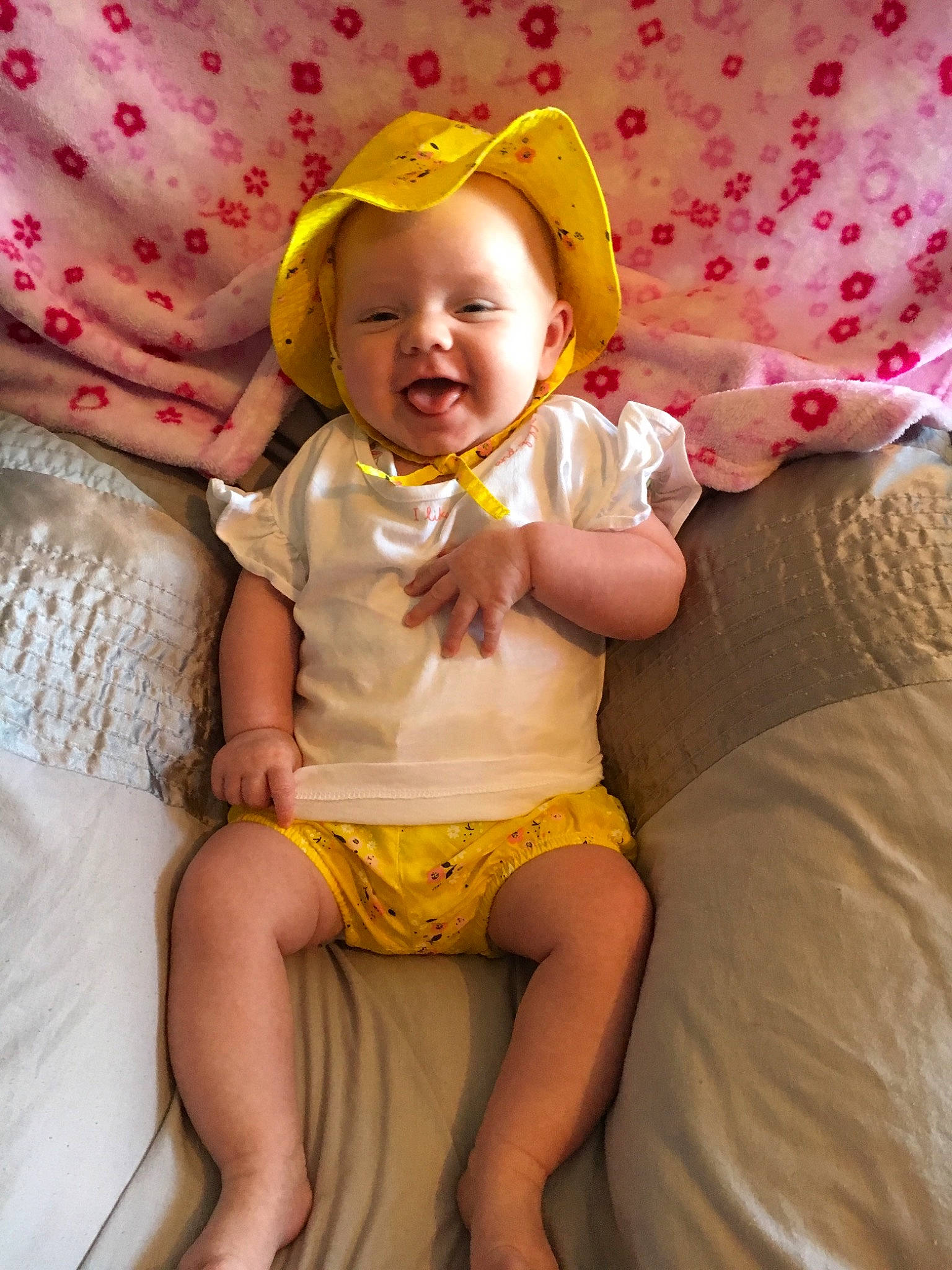 Darcey is registered to the contest to win money with this photo: baby, child, eye, fun, happy, leg, person, pink, sitting, skin, smile, toddler, yellow