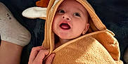 Bruno a rejoint le concours — aidez-le/la à gagner de superbes lots ! antlers, baby, blanket, brown, child, cozy, cute, expression, face, family, hand, happy, indoors, infant, person, smile, socks, soft, towel, warm