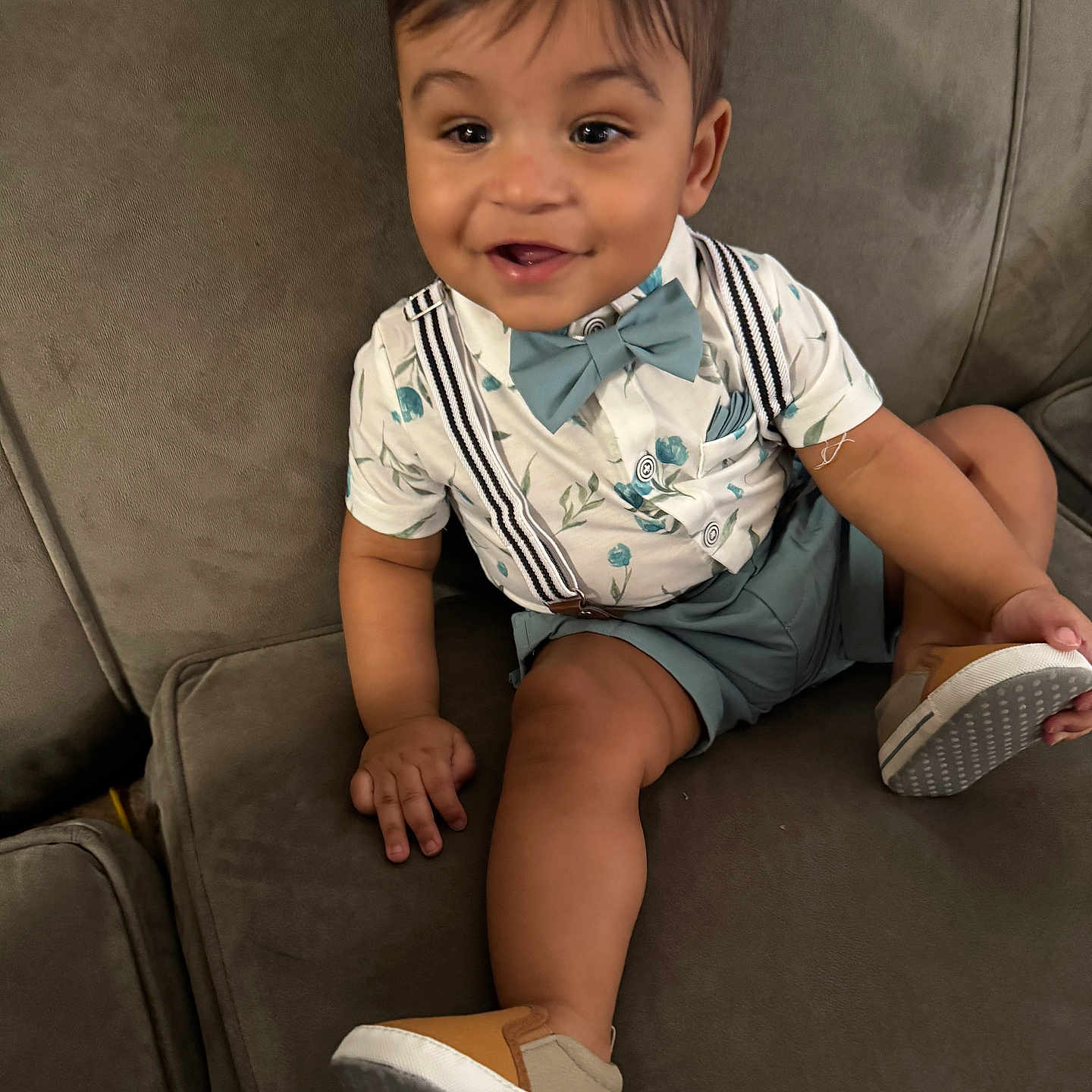 Elijah Daniel joined the competition — help win amazing prizes! baby, bow_tie, child, clothing, couch, cute, face, footwear, furniture, happy, indoors, person, portrait, shirt, shoe, shorts, sitting, smiling, suspenders, toddler