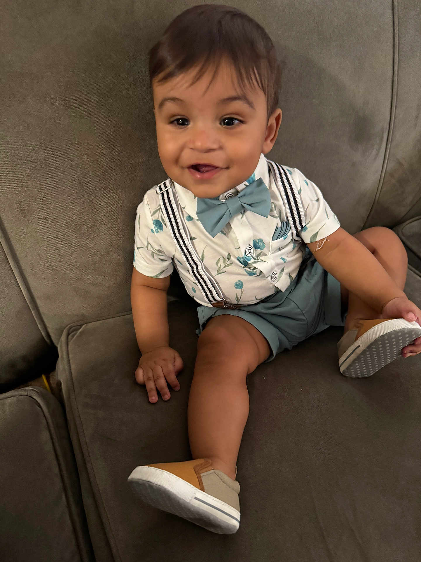 Elijah Daniel joined the competition — help win amazing prizes! toddler, child, smiling, sitting, couch, shoe, bow_tie, suspenders, shorts, shirt, happy, indoors, baby, portrait, cute, clothing, footwear, furniture, person, face