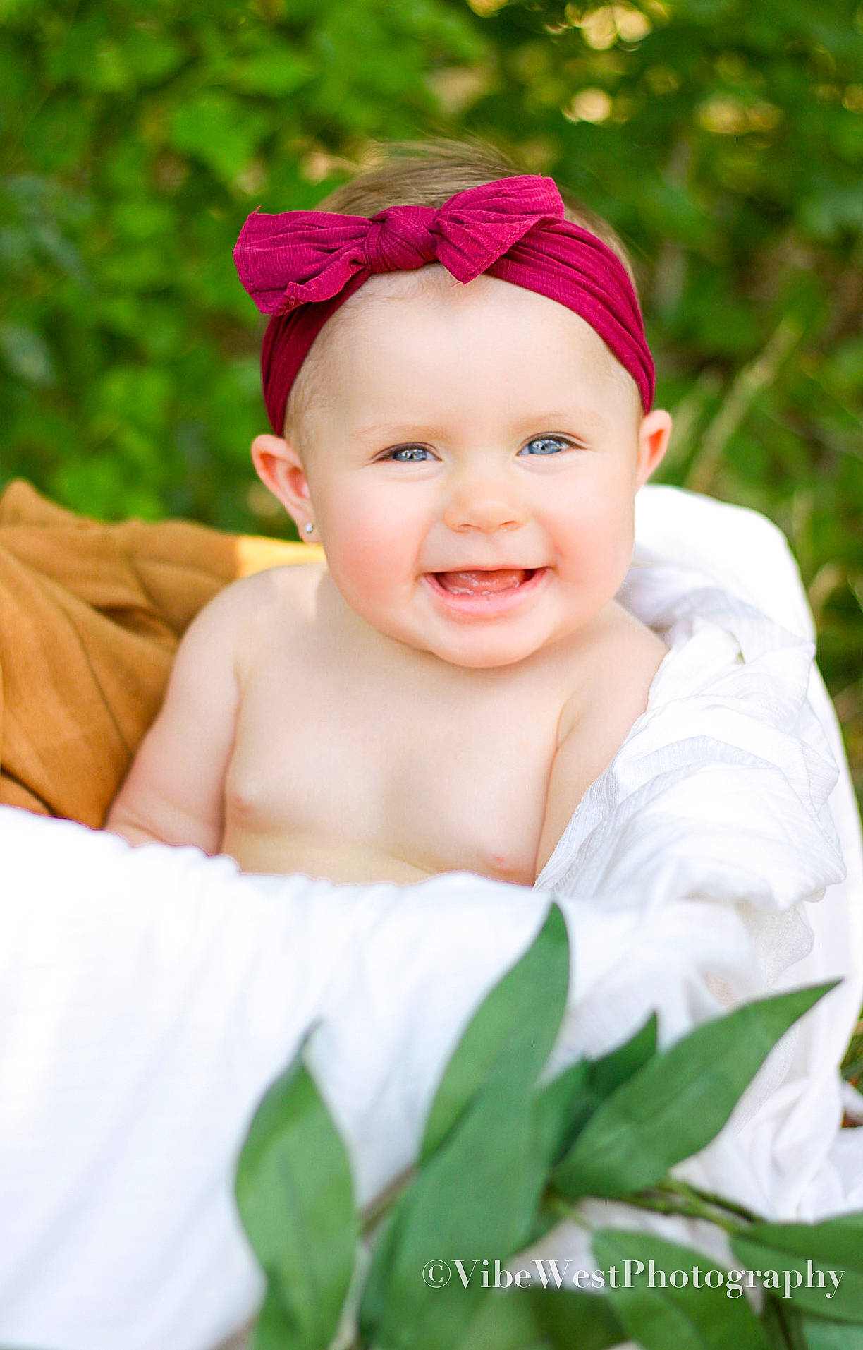Kynslee joined the competition — help win amazing prizes! arm, baby, baby_toddler_clothing, cap, chin, eye, face, facial_expression, grass, green, happy, headgear, headwear, human_body, joy, lip, person, petal, pink, plant