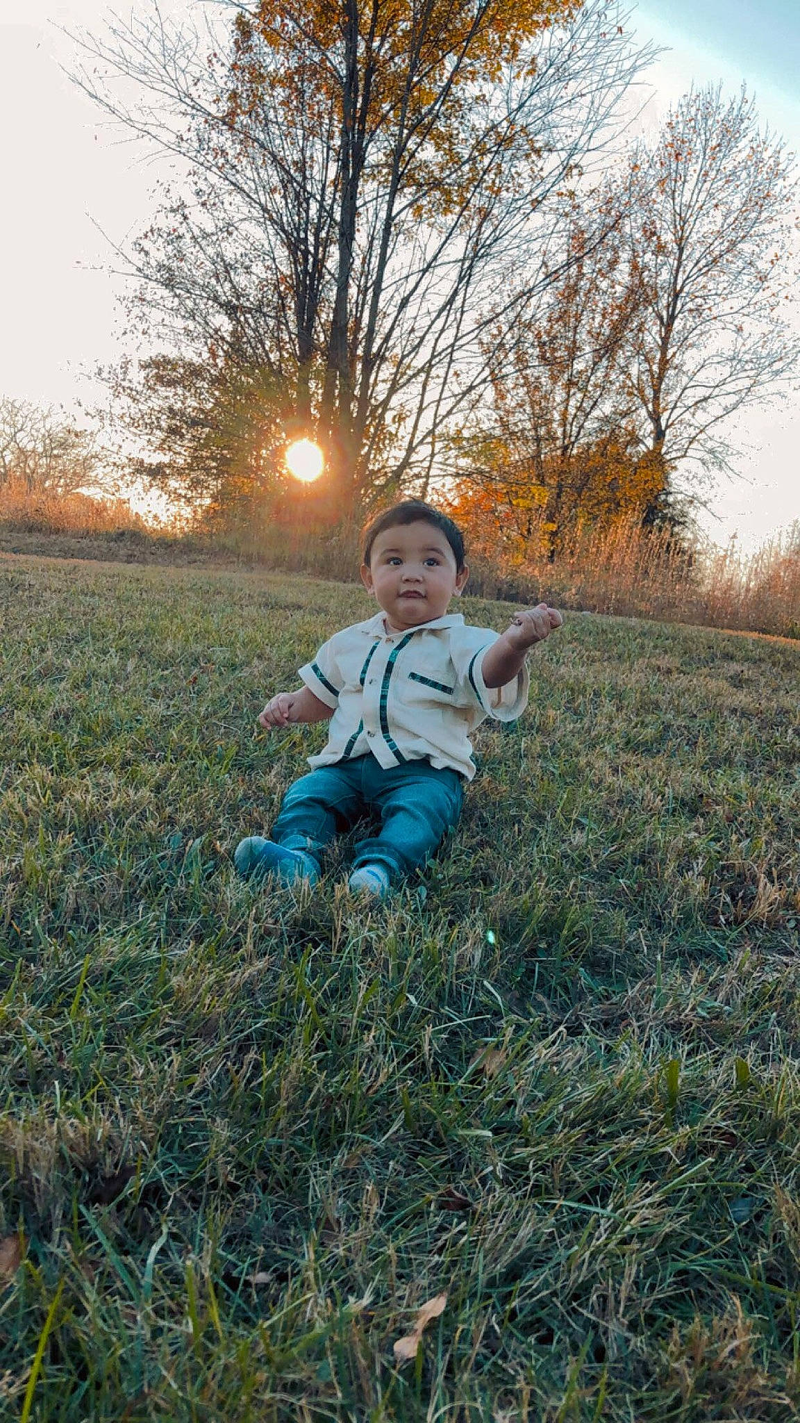 Ismael is registered to the contest to win money with this photo: autumn, baby, baby_toddler_clothing, backlighting, child, field, grass, lens_flare, meadow, nose, overall, people_in_nature, person, play, prairie, sun, sunlight, sunrise, sunset, toddler