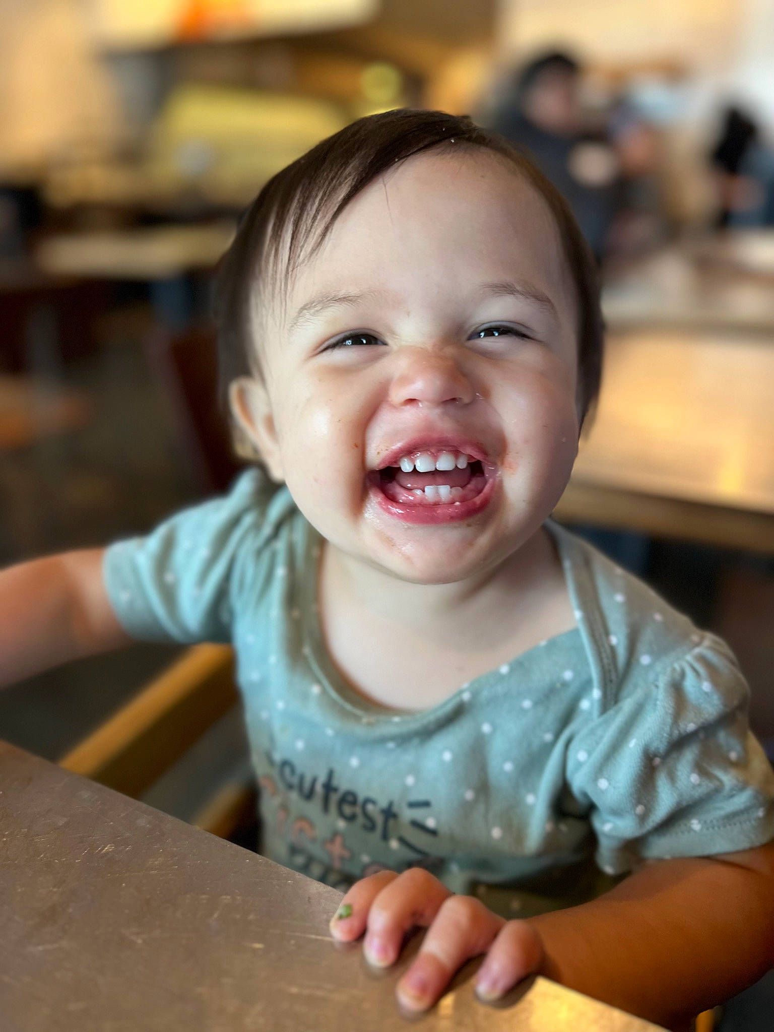 Aries is registered to the contest to win money with this photo: baby, baby_toddler_clothing, chair, cheek, child, chin, eye, fun, gesture, happy, iris, lip, mouth, nose, person, sitting, skin, sleeve, table, toddler