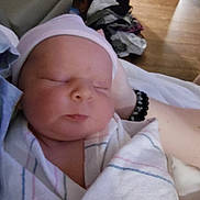 Weston joined the competition — help win amazing prizes! newborn, baby, infant, sleeping, blanket, cap, person, indoor, hospital, resting, closeup, soft, peaceful, wrapped, human, care, comfort, floor, arm, clothing