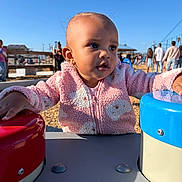 Desire joined the competition — help win amazing prizes! background, blue_sky, button, casual_clothing, child, curious, daylight, exploring, face, happy, head, leisure, outdoor, park, people, person, pink_jacket, playground, sunlight, toddler