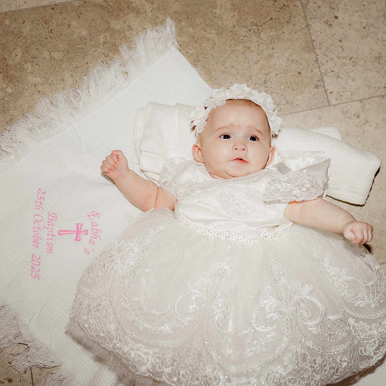 éabha is registered to the contest to win money with this photo: baby, baptism, celebration, ceremony, child, cloth, cute, dress, embroidery, floor, headband, indoors, infant, lace, laying_down, newborn, person, portrait, tiled_floor, white_dress