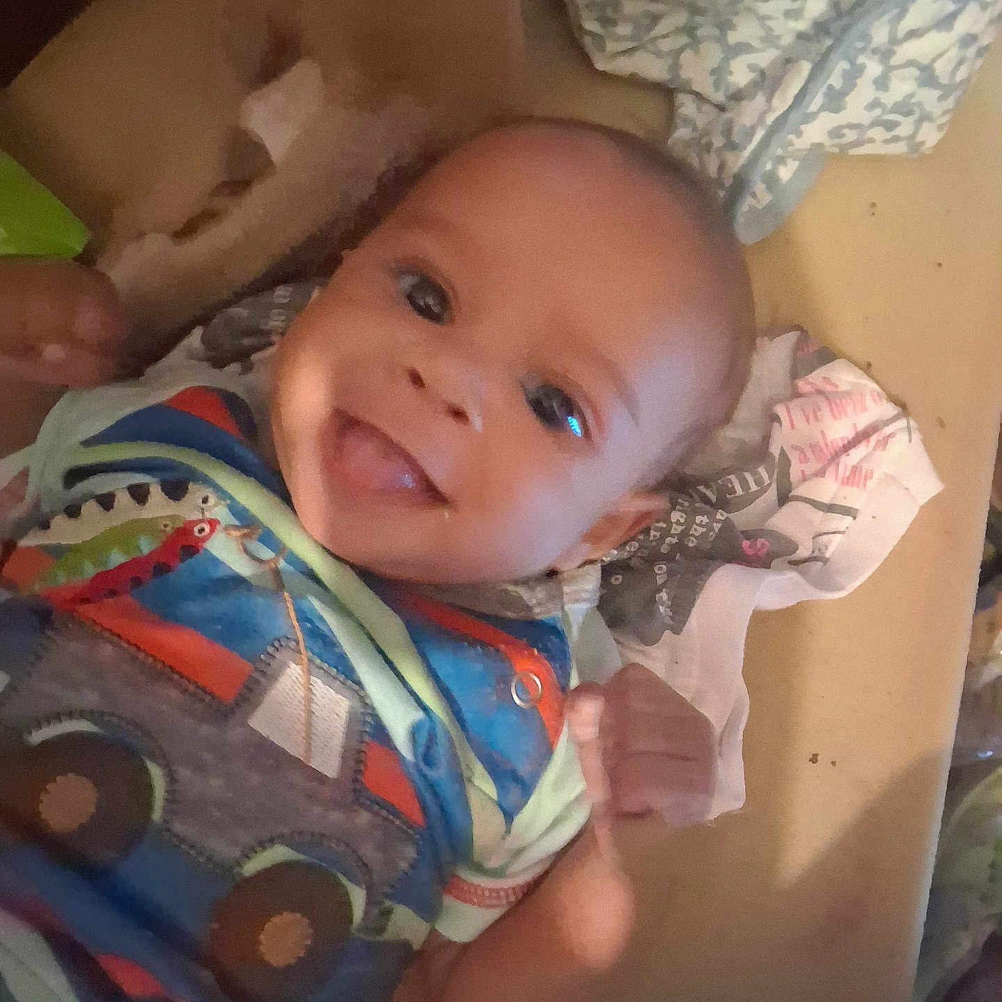 Kaysan joined the competition — help win amazing prizes! baby, infant, child, smiling, portrait, close_up, face, eyes, clothing, colorful_clothing, blanket, plush_toy, toy, indoors, cozy, lying_down, happy, photography, home, hand
