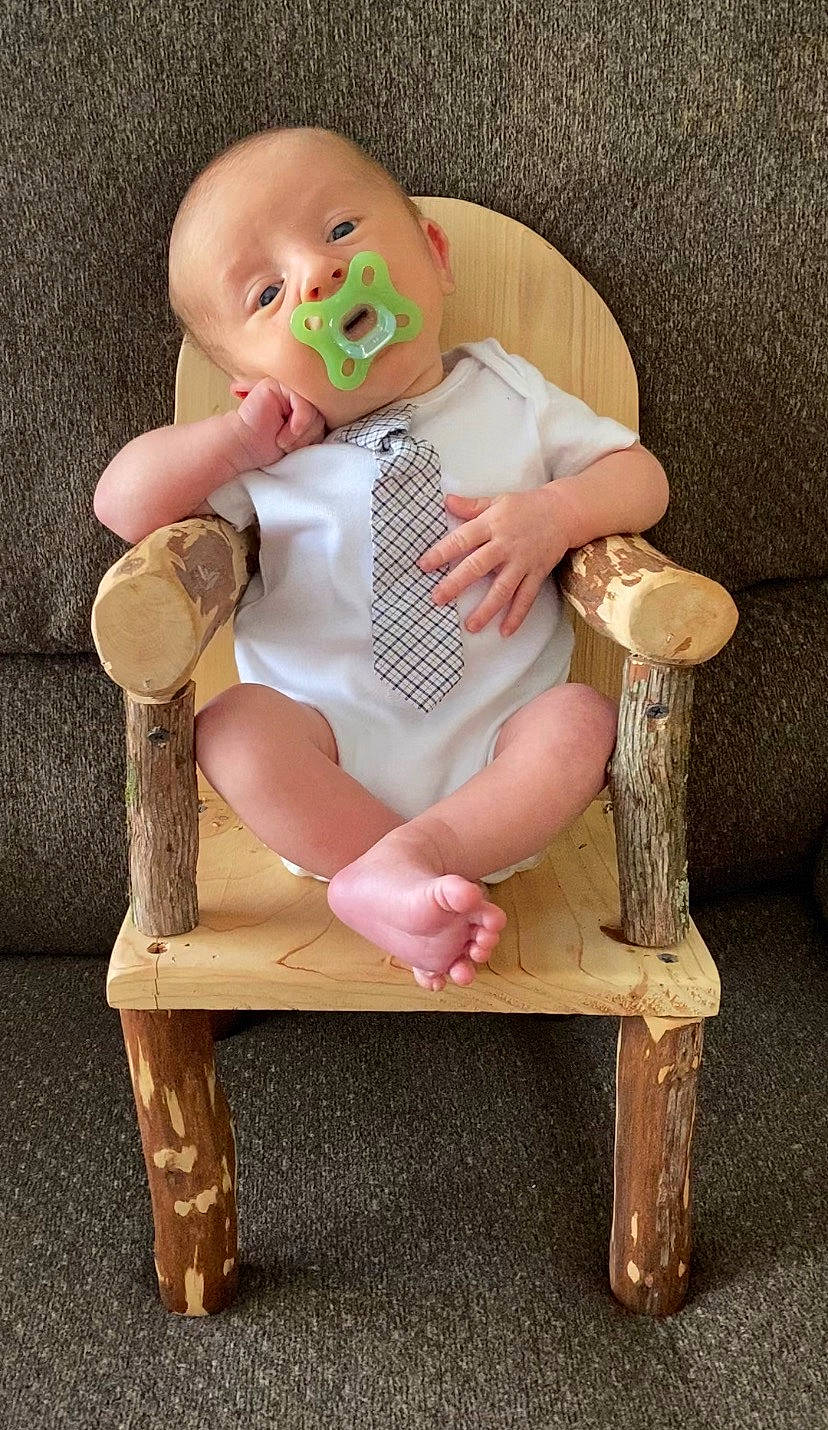 Prince is registered to the contest to win money with this photo: baby, baby_products, baby_toddler_clothing, baby_toys, chair, cheek, child, comfort, finger, hand, happy, head, human_body, leg, person, sitting, skin, thigh, toddler, toy