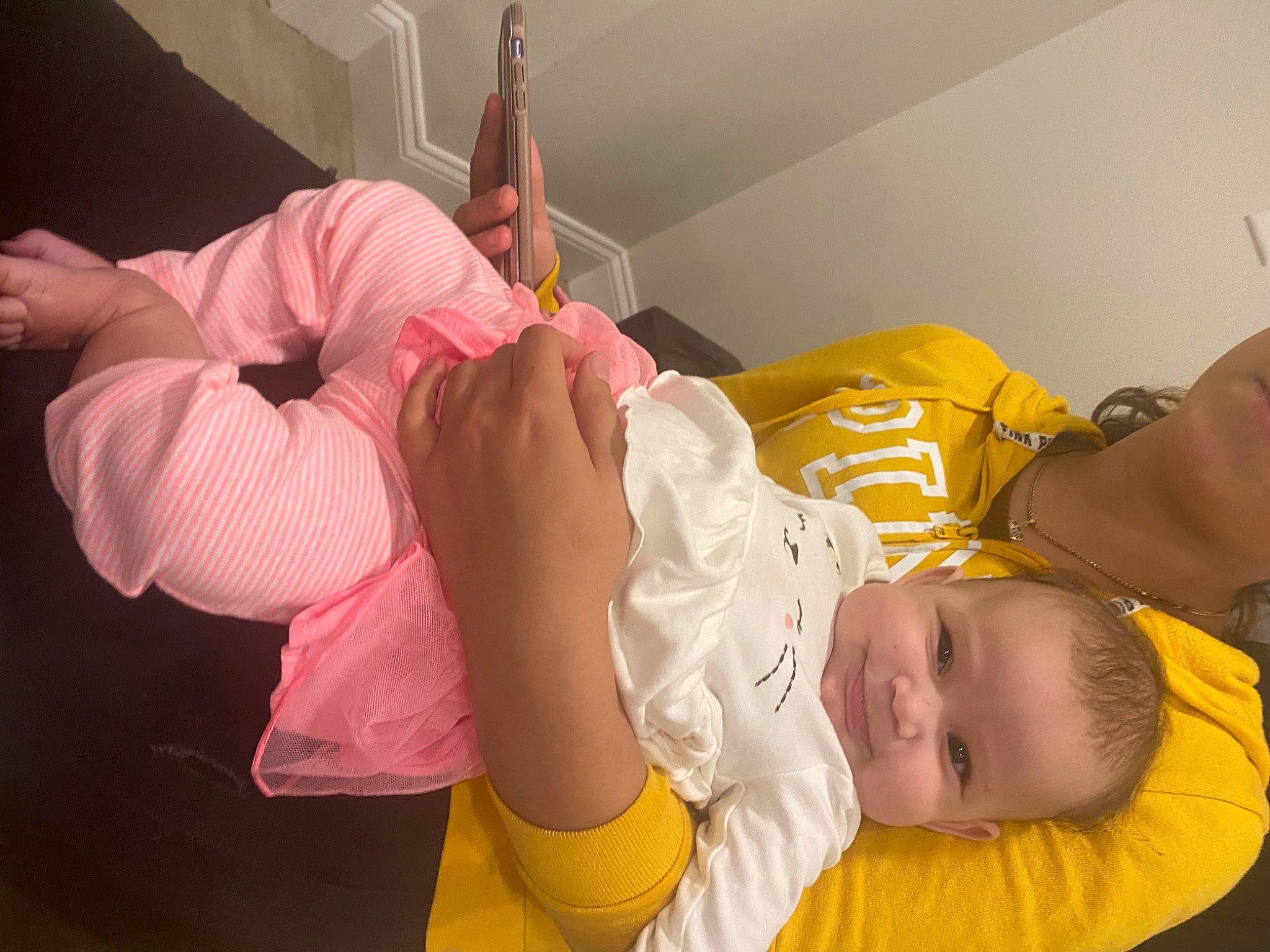 Karmella is registered to the contest to win money with this photo: abdomen, arm, baby, baby_toddler_clothing, bed, child, comfort, elbow, fun, gesture, human_leg, joint, knee, person, room, sitting, sock, thigh, thumb, toddler