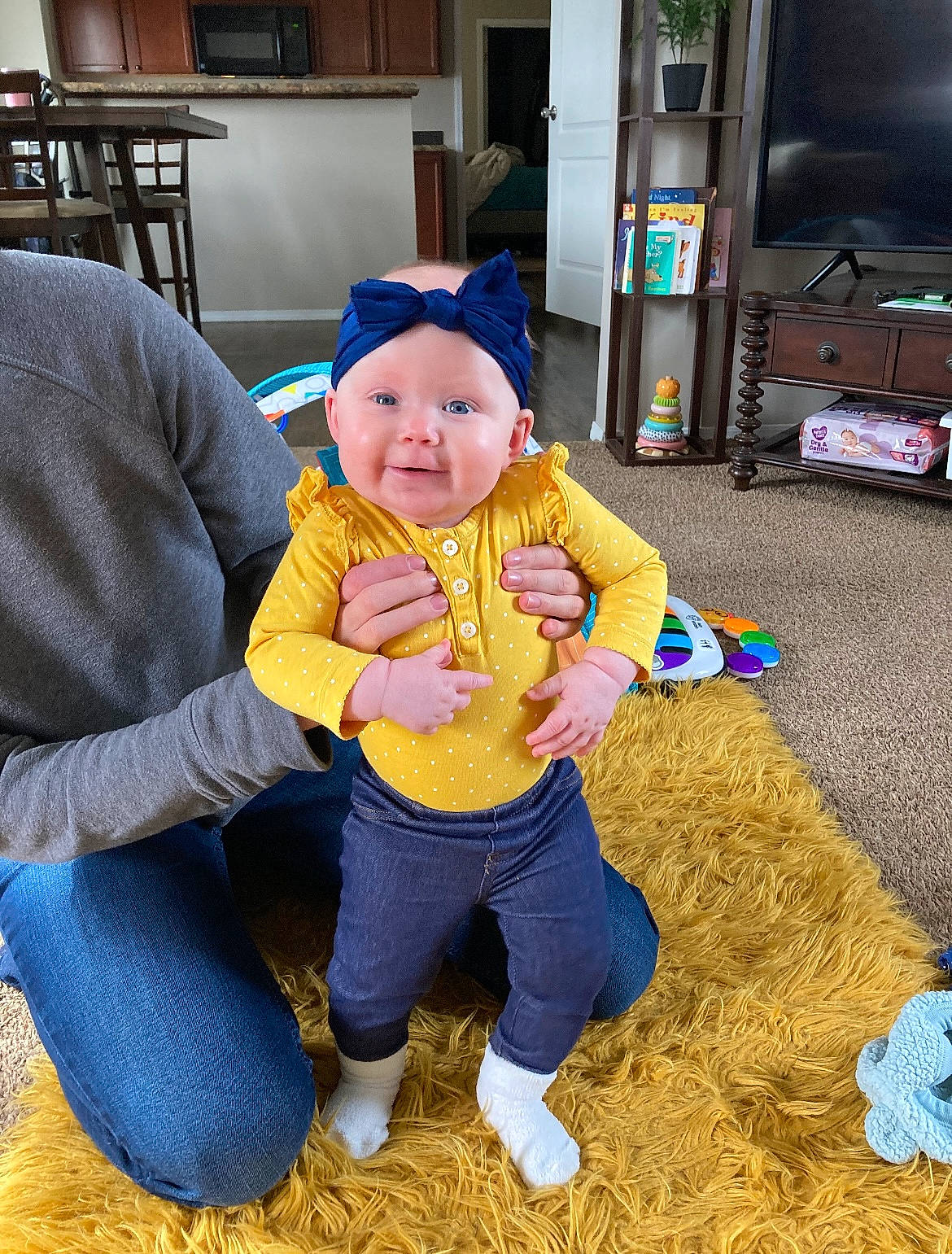 Dahlia is registered to the contest to win money with this photo: baby, baby_toddler_clothing, cap, chair, child, couch, event, flooring, fun, grass, happy, hat, headwear, holiday, lap, leisure, people_in_nature, person, sitting, television