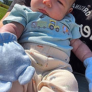 Zander joined the competition — help win amazing prizes! baby, infant, child, blue_clothing, mittens, outdoor, sunny_day, sky, clouds, person_holding, cute, patterned_pants, portrait, young_child, casual_clothing, nature, grass, face, expression, soft_light
