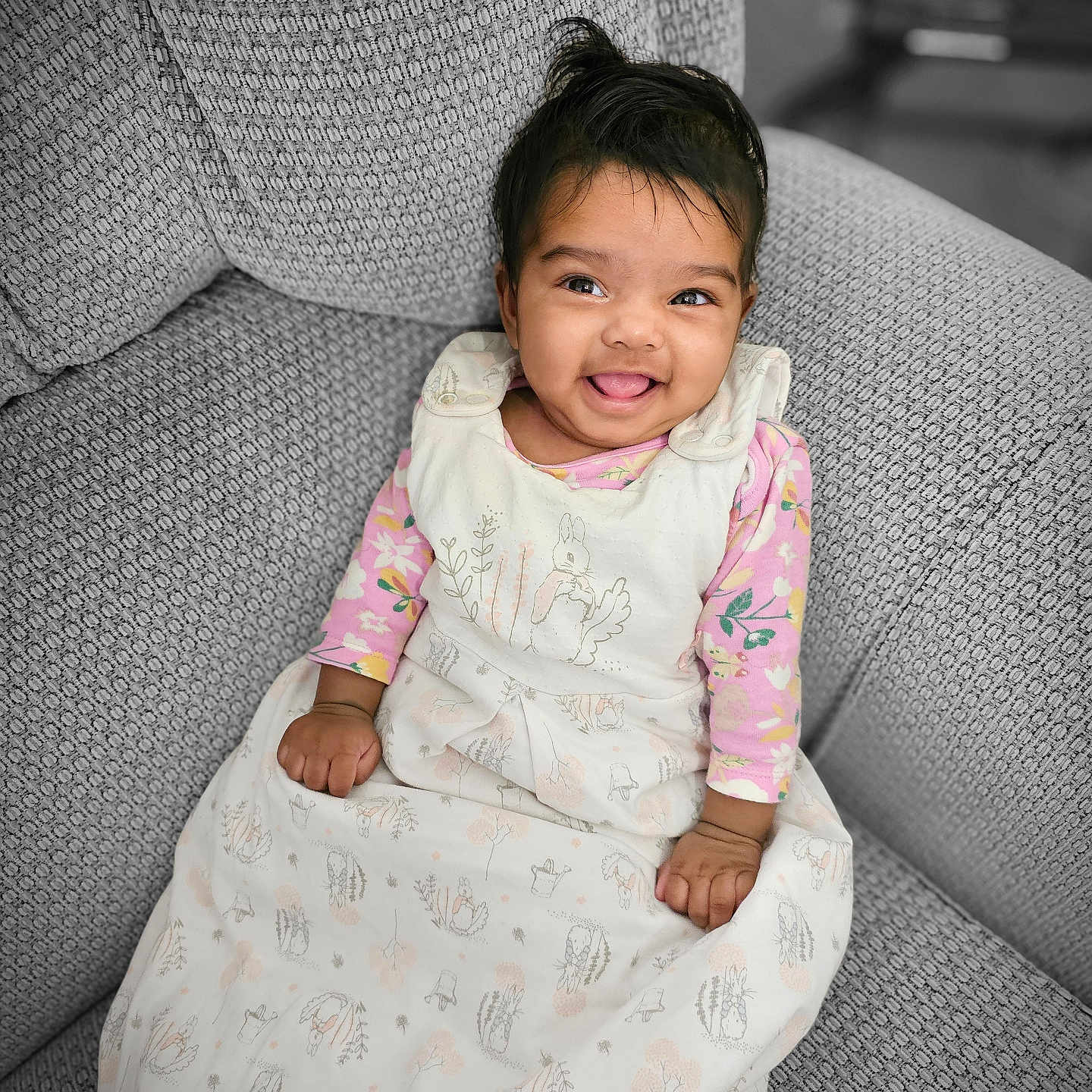 Aida joined the competition — help win amazing prizes! baby, babylaughing, blanket, chair, clothing, couch, cushion, dress, face, furniture, happy, head, homedecor, laughing, longsleeve, person, photography, portrait, sitting, smile