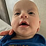 Oakley joined the competition — help win amazing prizes! baby, infant, face, eyes, mouth, hand, blue_shirt, lemon_graphic, text, skin, head, person, closeup, indoor, expression, cute, young_child, portrait, child, support