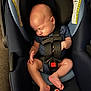baby, car_seat, sleeping, infant, blue, safety_harness, child, indoors, toddler, seatbelt, clothing, footwear, head, face, skin, hand, leg, furniture, comfort, peaceful