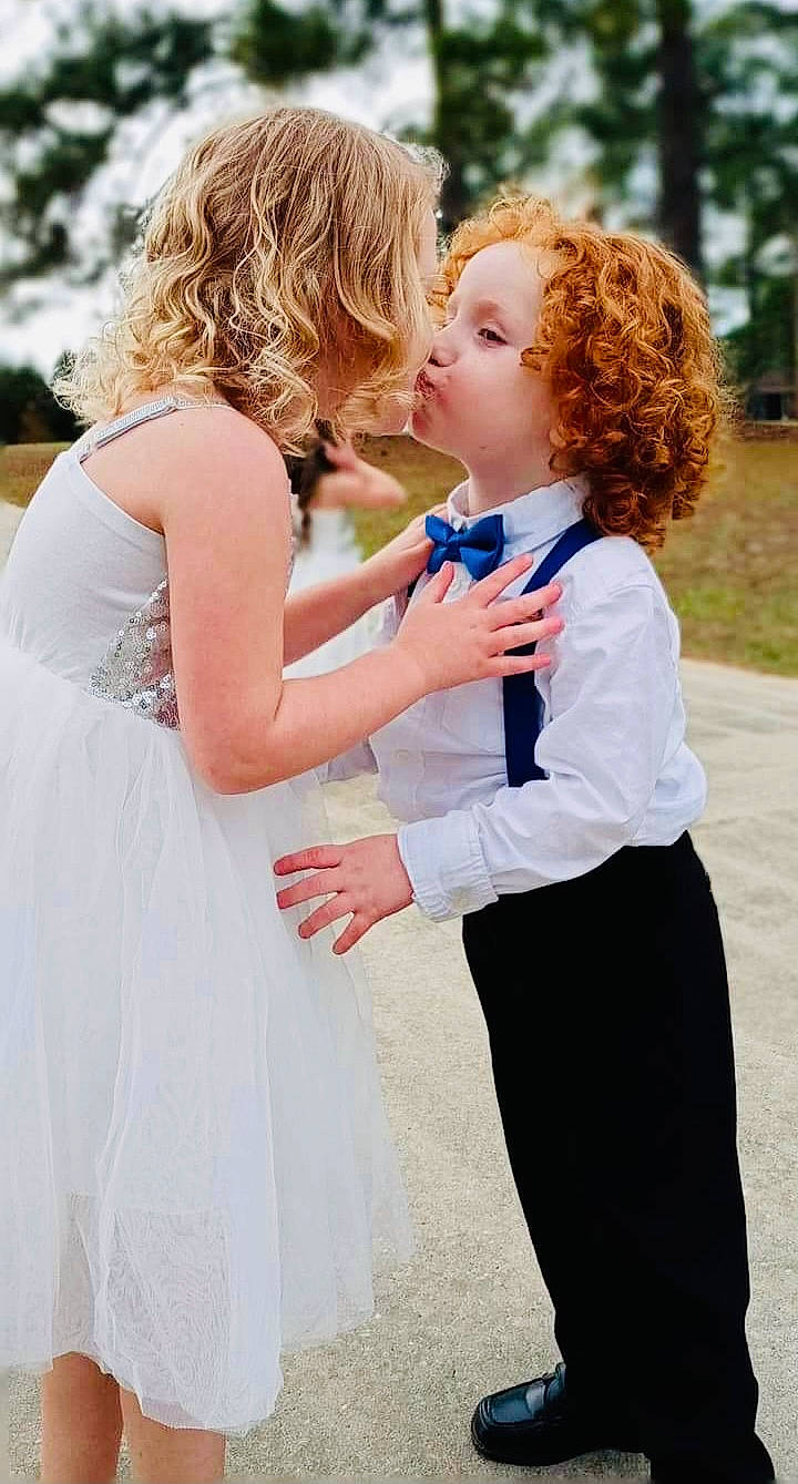 Christian joined the competition — help win amazing prizes! baby, bridal_clothing, bridal_party_dress, clothing, dress, formal_wear, gesture, gown, grass, hair, hairstyle, happy, kiss, people, people_in_nature, person, photograph, red, summer, toddler