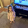 Brooklyn is registered to the contest to win money with this photo: child, girl, toddler, portrait, standing, bathrobe, barefoot, indoors, living_room, television, cartoon, dog, toys, carpet, furniture, home, family, brown_hair, looking_at_camera, cozy