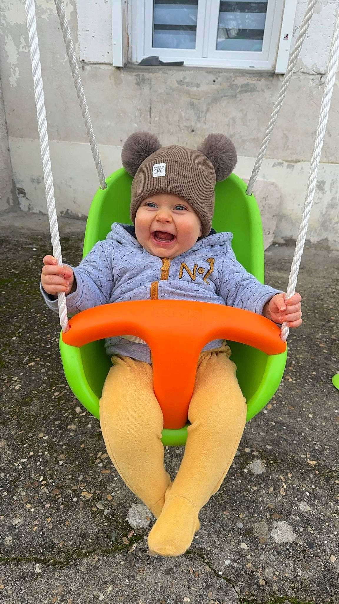 Kayden participe au concours pour gagner de l'argent avec cette photo : baby, baby_toddler_clothing, chair, child, fun, grass, green, hand, happy, hat, headwear, human_body, leisure, outdoor_play_equipment, person, recreation, sitting, smile, swing, t_shirt