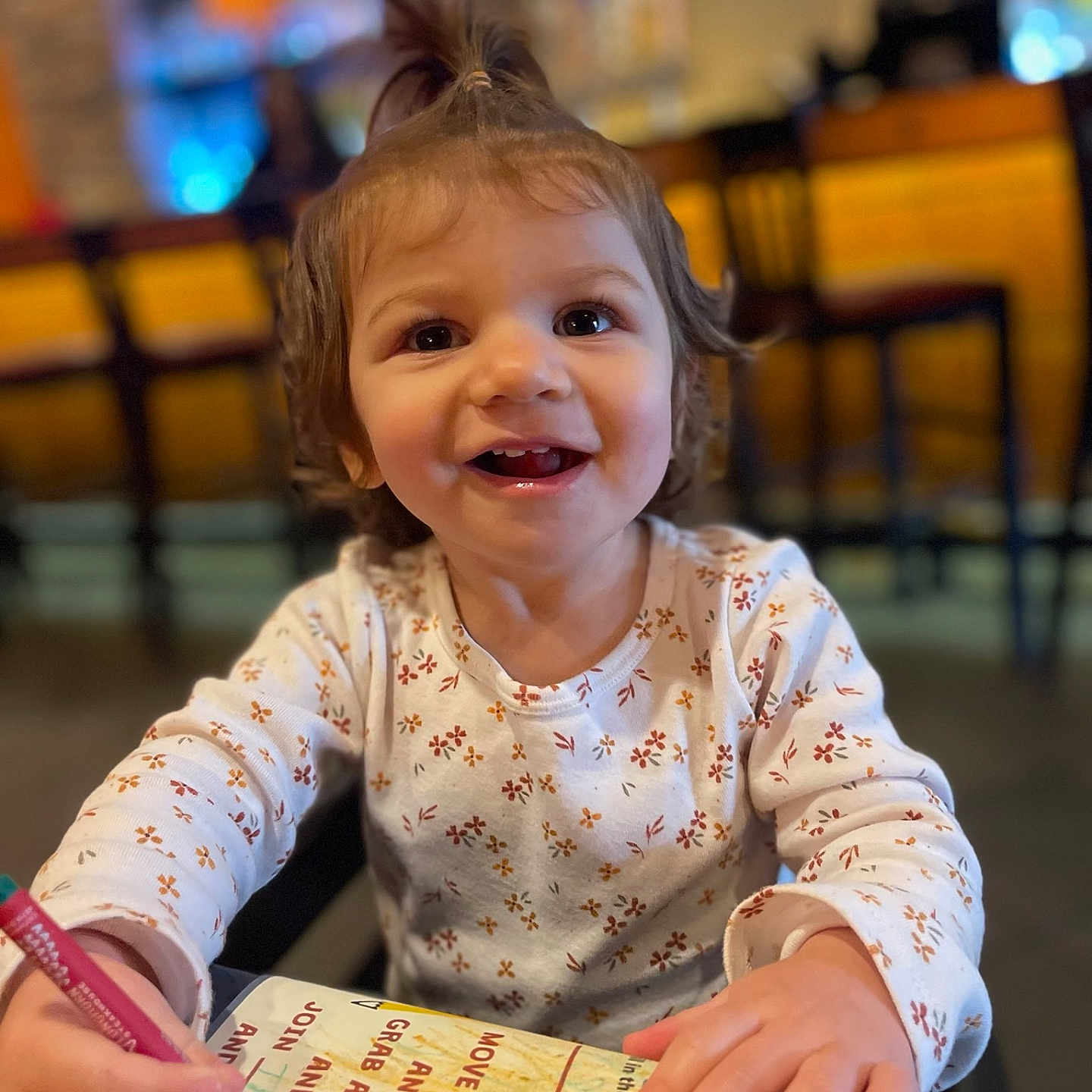 Amethyst is registered to the contest to win money with this photo: bodypart, child, face, female, finger, furniture, girl, hand, happy, head, indoors, person, photography, portrait, restaurant, sitting, smile, table, text, wood
