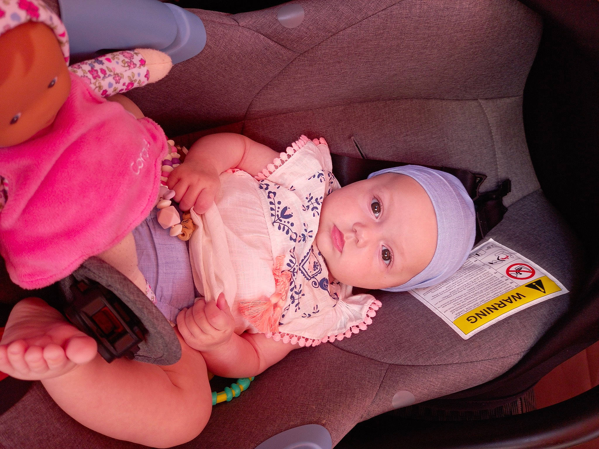 Assya participe au concours pour gagner de l'argent avec cette photo : arm, baby, baby_carriage, baby_toddler_clothing, car_seat, cheek, child, comfort, finger, hand, headgear, headwear, human_body, lap, leg, mouth, nail, person, pink, skin