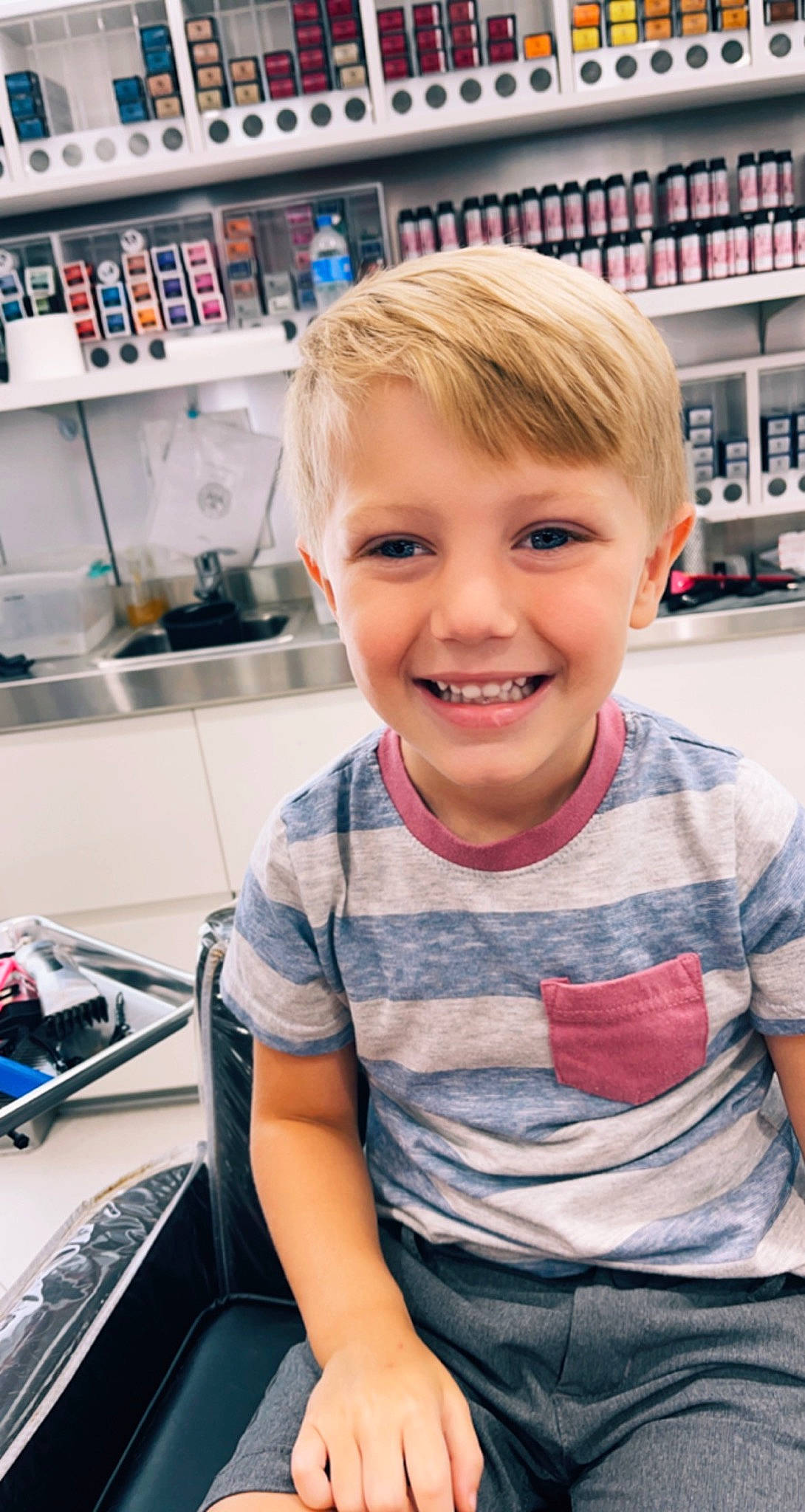 Trevor is registered to the contest to win money with this photo: automotive_design, cheek, child, chin, engineering, eyebrow, eyelash, eyewear, forehead, fun, hair, happy, joy, muscle, person, shelf, sitting, skin, smile, t_shirt