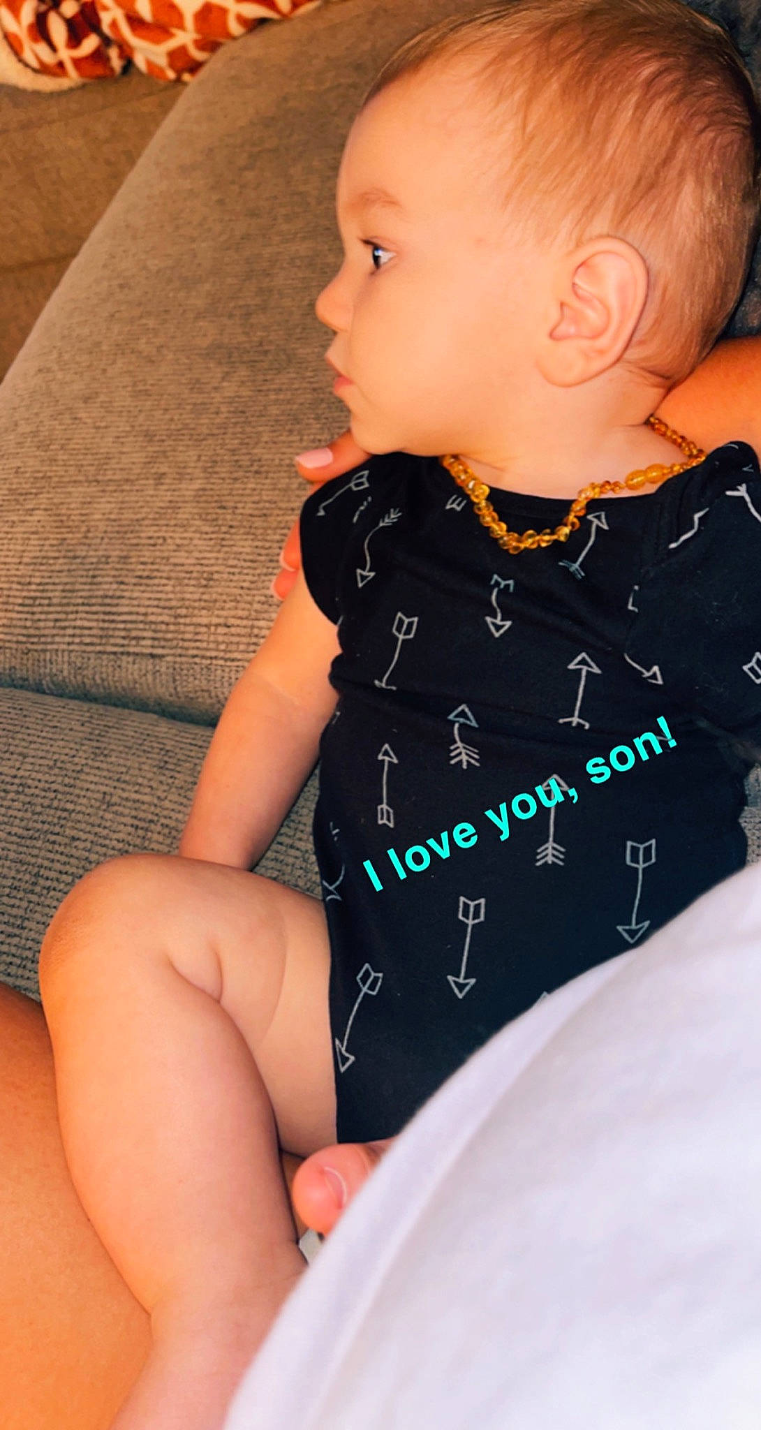 Brennan is registered to the contest to win money with this photo: arm, baby_toddler_clothing, cheek, comfort, facial_expression, finger, hairstyle, hand, human_body, iris, joint, leg, lip, neck, organ, person, shoulder, skin, sleeve, textile