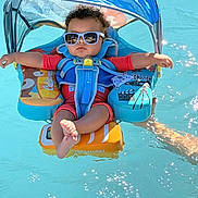 Giovanni joined the competition — help win amazing prizes! baby, baby_float, blue_water, child, colorful, float, infant, life_vest, outdoor, pool, portrait, recreation, relaxing, sitting, summer, sunglasses, sunlight, swimming, vacation, water