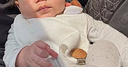 Giovanni joined the competition — help win amazing prizes! baby, infant, child, portrait, car, car_seat, white_outfit, curly_hair, face, eyes, hand, sitting, indoors, vehicle, sunlight, window, trees, blanket, pacifier_clip, cozy