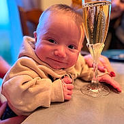 Marlonn a rejoint le concours — aidez-le/la à gagner de superbes lots ! baby, child, smiling, face, hand, glass, table, bokeh, adult, background, hoodie, skin, fingernails, person, indoor, drink, celebration, closeup, portrait, happy