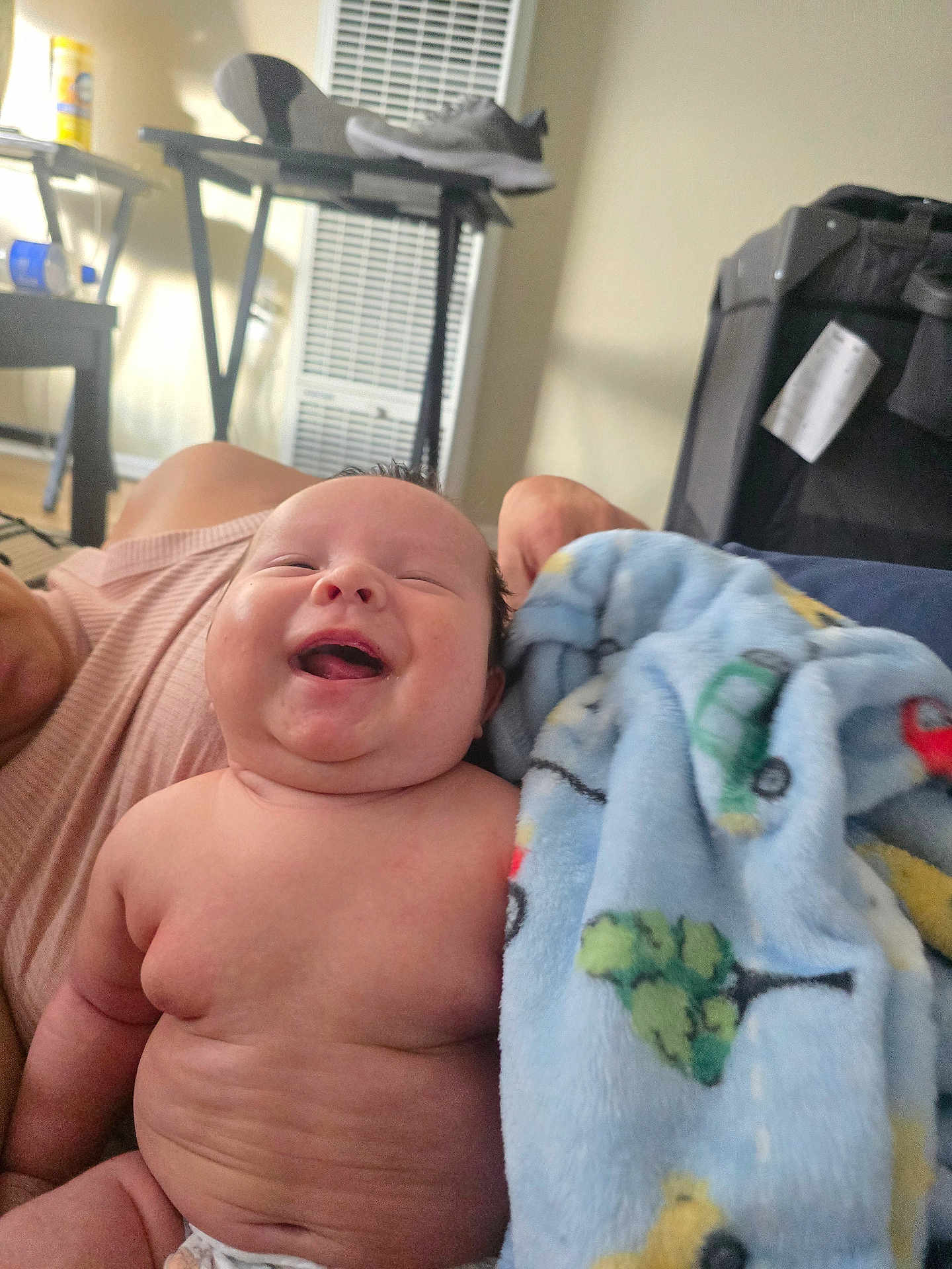 Iitanon is registered to the contest to win money with this photo: baby, smiling, laughing, blanket, blue_blanket, patterned_blanket, diaper, indoor, person, furniture, shoe, table, window_blind, light, happy, child, cute, infant, skin, face