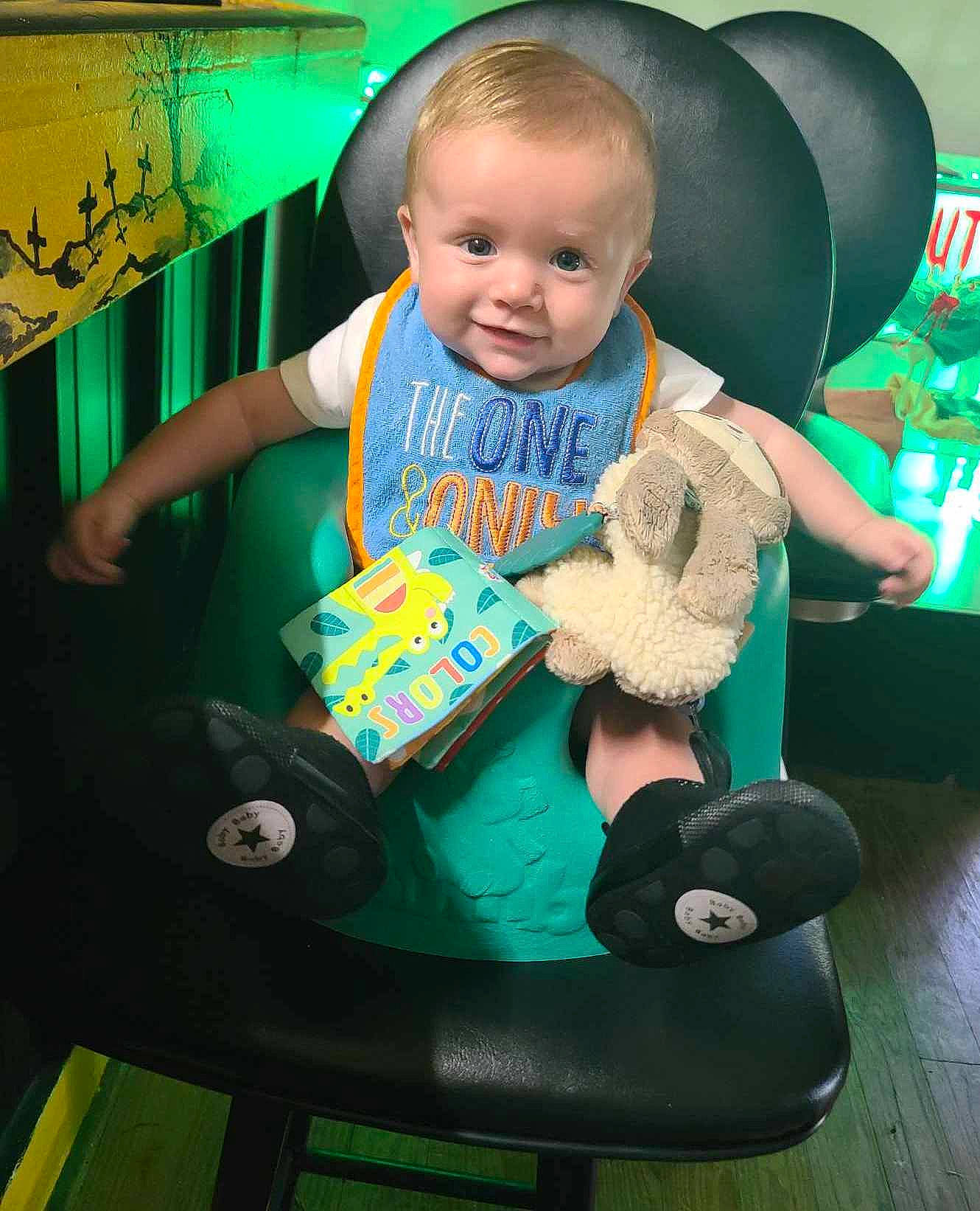 Christopher joined the competition — help win amazing prizes! baby, baby_carriage, baby_products, baby_toddler_clothing, chair, child, comfort, fun, green, happy, hat, lap, leisure, person, play, riding_toy, sitting, sun_hat, t_shirt, toddler