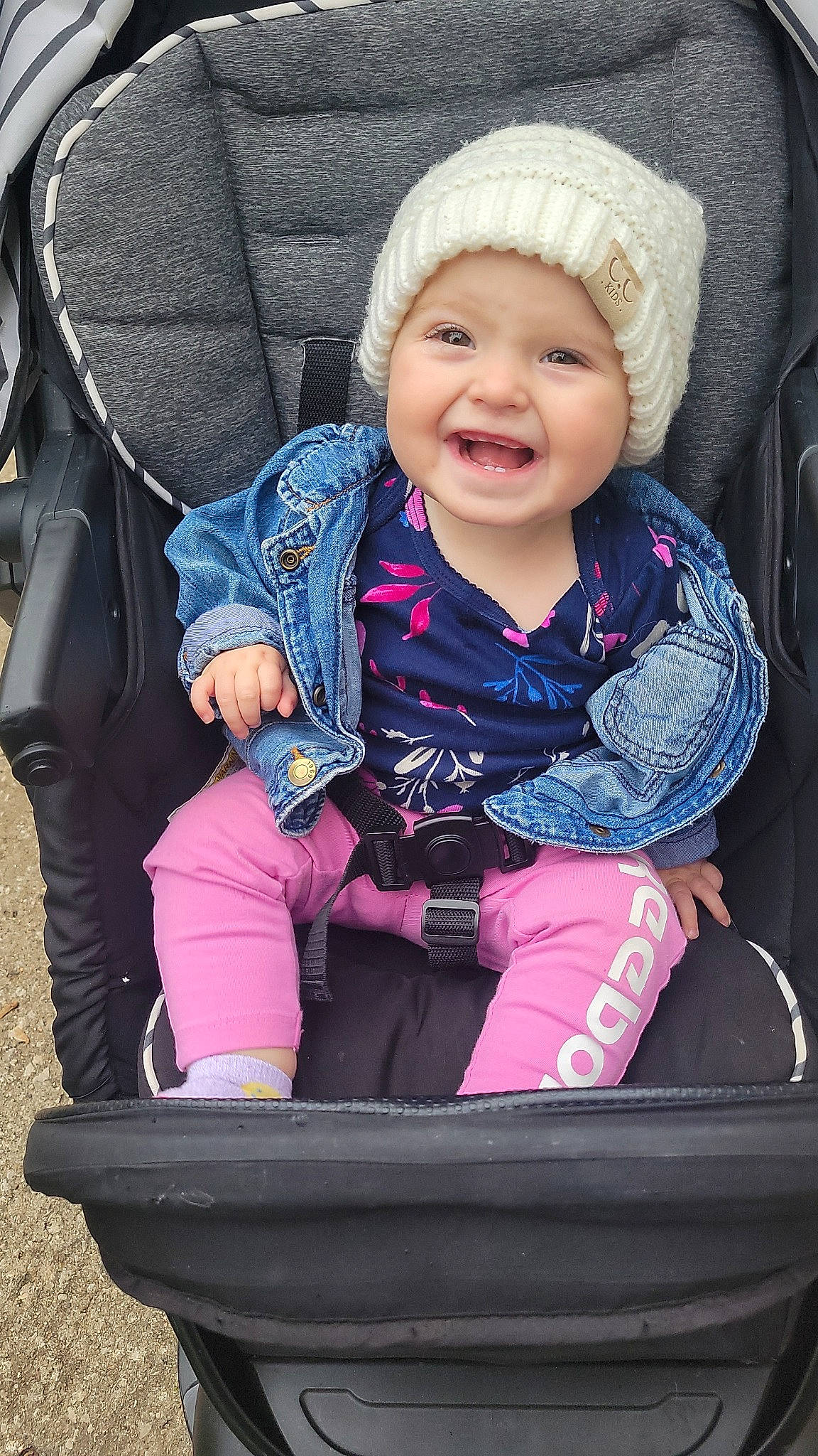 Rylee is registered to the contest to win money with this photo: baby, baby_carriage, baby_toddler_clothing, black, cheek, comfort, eye, face, facial_expression, headwear, joy, organ, outerwear, people, person, photograph, pink, product, purple, sleeve