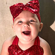 Khloe joined the competition — help win amazing prizes! baby, child, smiling, red_bow, headband, sequins, red_clothing, happy, portrait, cute, infant, face, young_child, joyful, apparel, cheerful, indoor, skin, person, headwear