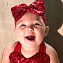 baby, child, smiling, red_bow, headband, sequins, red_clothing, happy, portrait, cute, infant, face, young_child, joyful, apparel, cheerful, indoor, skin, person, headwear
