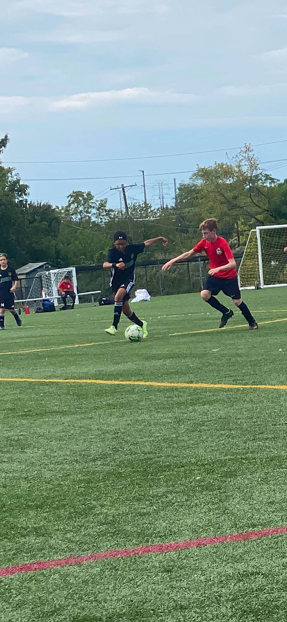 Lance is registered to the contest to win money with this photo: ball, ball_game, blurred, championship, cloud, football, football_player, grass, leisure, person, plant, player, playing_sports, sky, soccer, soccer_ball, soccer_player, sports, sports_equipment, team_sport