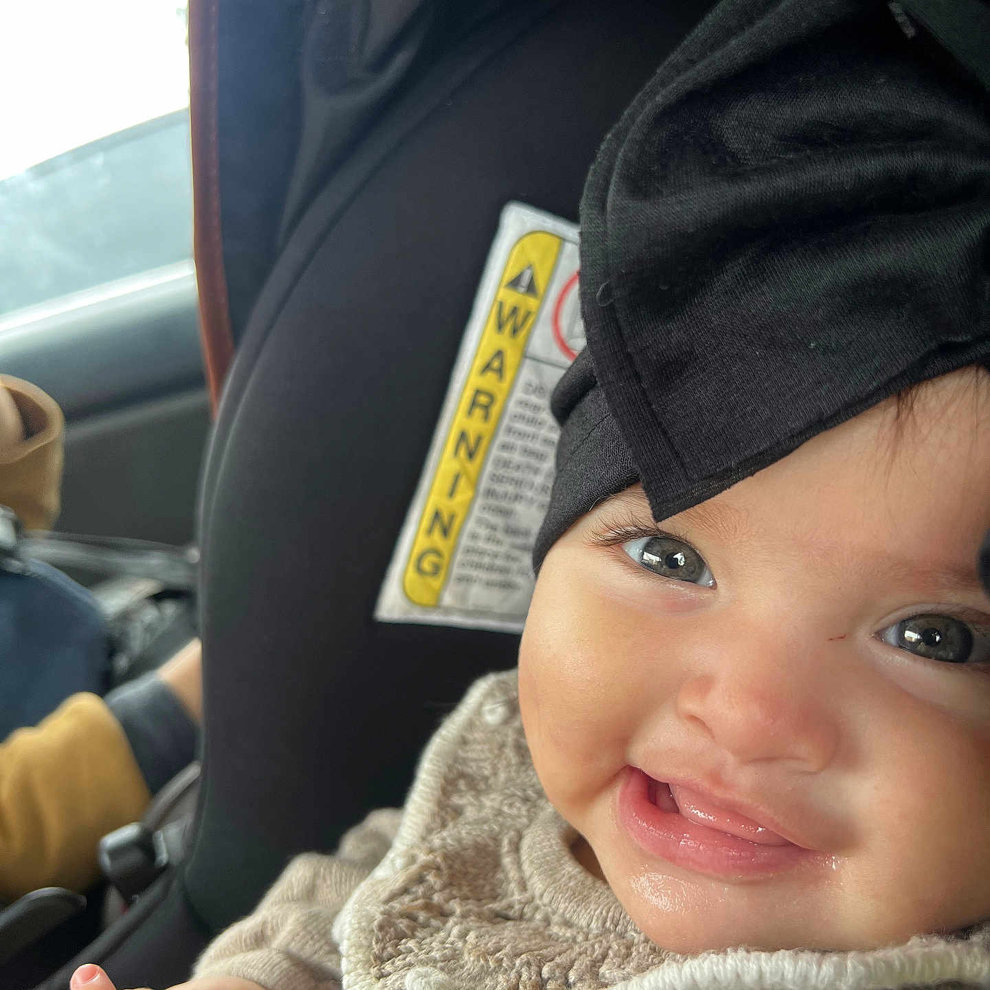 Mia is registered to the contest to win money with this photo: adult, baby, bodypart, clothing, coat, cushion, face, finger, hand, happy, hat, head, homedecor, jacket, male, man, person, photography, portrait, smile