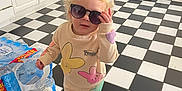 Zaylah is registered to the contest to win money with this photo: accessories, appliance, baby, clothing, device, electricaldevice, face, glasses, head, hosiery, indoors, interiordesign, pants, person, photography, portrait, refrigerator, sock, sunglasses, wood