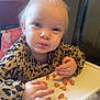 Zaylah is registered to the contest to win money with this photo: baby, blonde, bodypart, cutlery, eating, face, finger, food, hair, hand, head, lunch, meal, nail, person, photography, portrait, spoon, sweets, wood