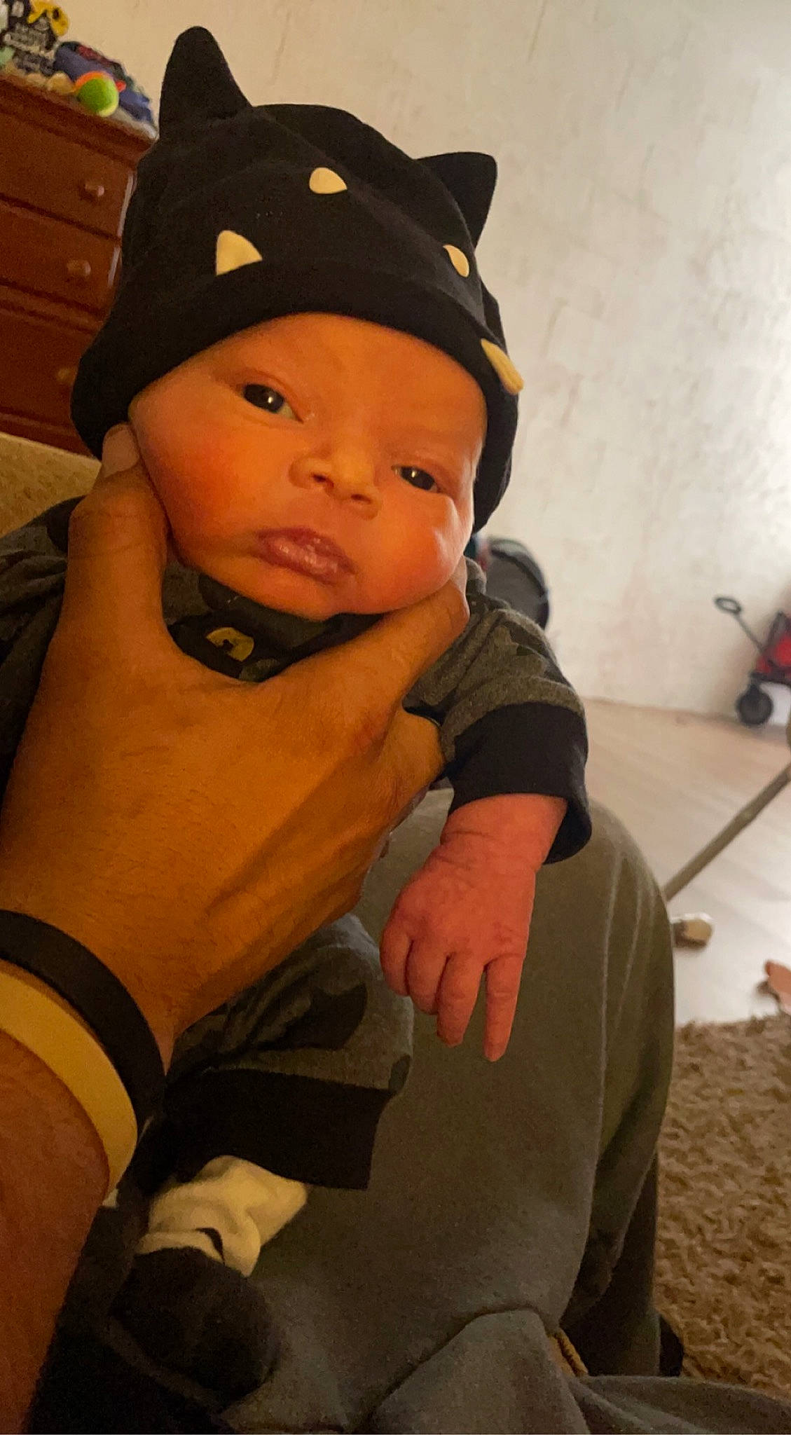 Zaylah is registered to the contest to win money with this photo: arm, baby, baby_toddler_clothing, cabinetry, cap, cheek, chin, comfort, eye, eyebrow, face, facial_expression, fashion_accessory, finger, fun, gesture, happy, headwear, person, sleeve