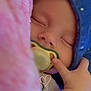 Ulysse participe au concours pour gagner de l'argent avec cette photo : baby, sleeping, pacifier, blue_hood, pink_blanket, hand, infant, cozy, cute, peaceful, closeup, soft_texture, newborn, child, face, apparel, resting, tiny_fingers, indoor, warm